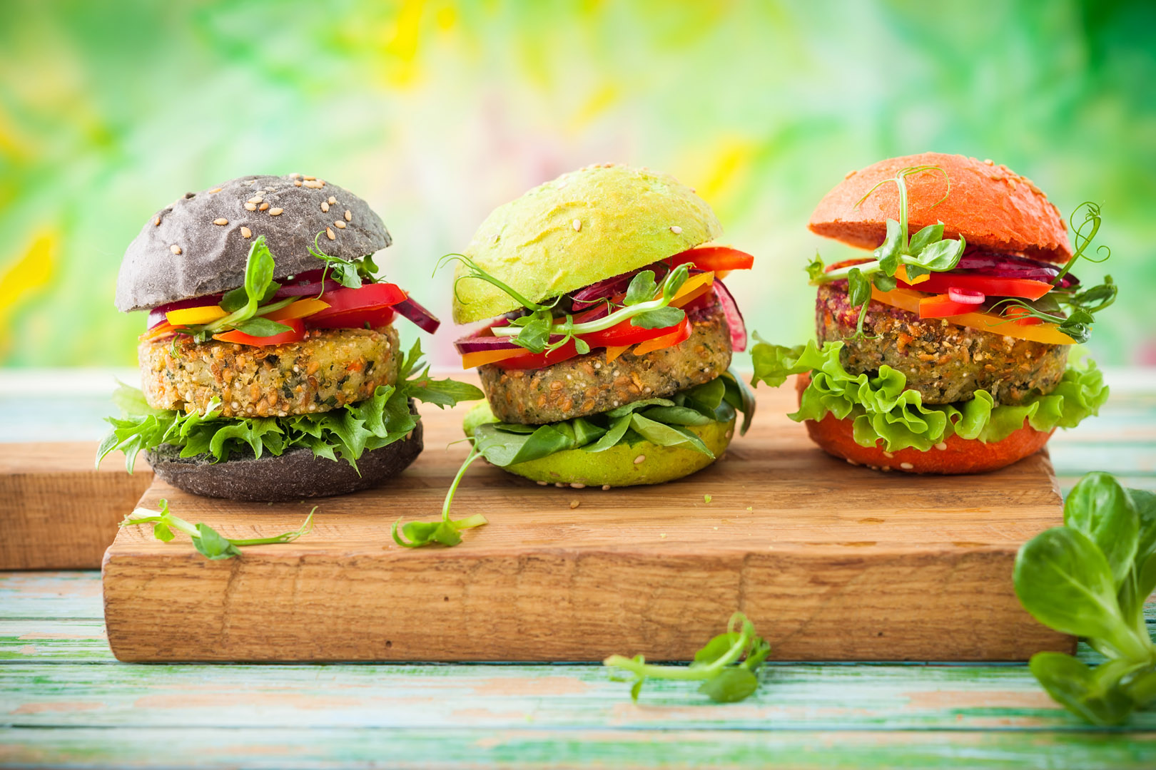 Red, green,black mini burgers with quinoa and vegetables